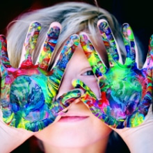 young girl with painted hands